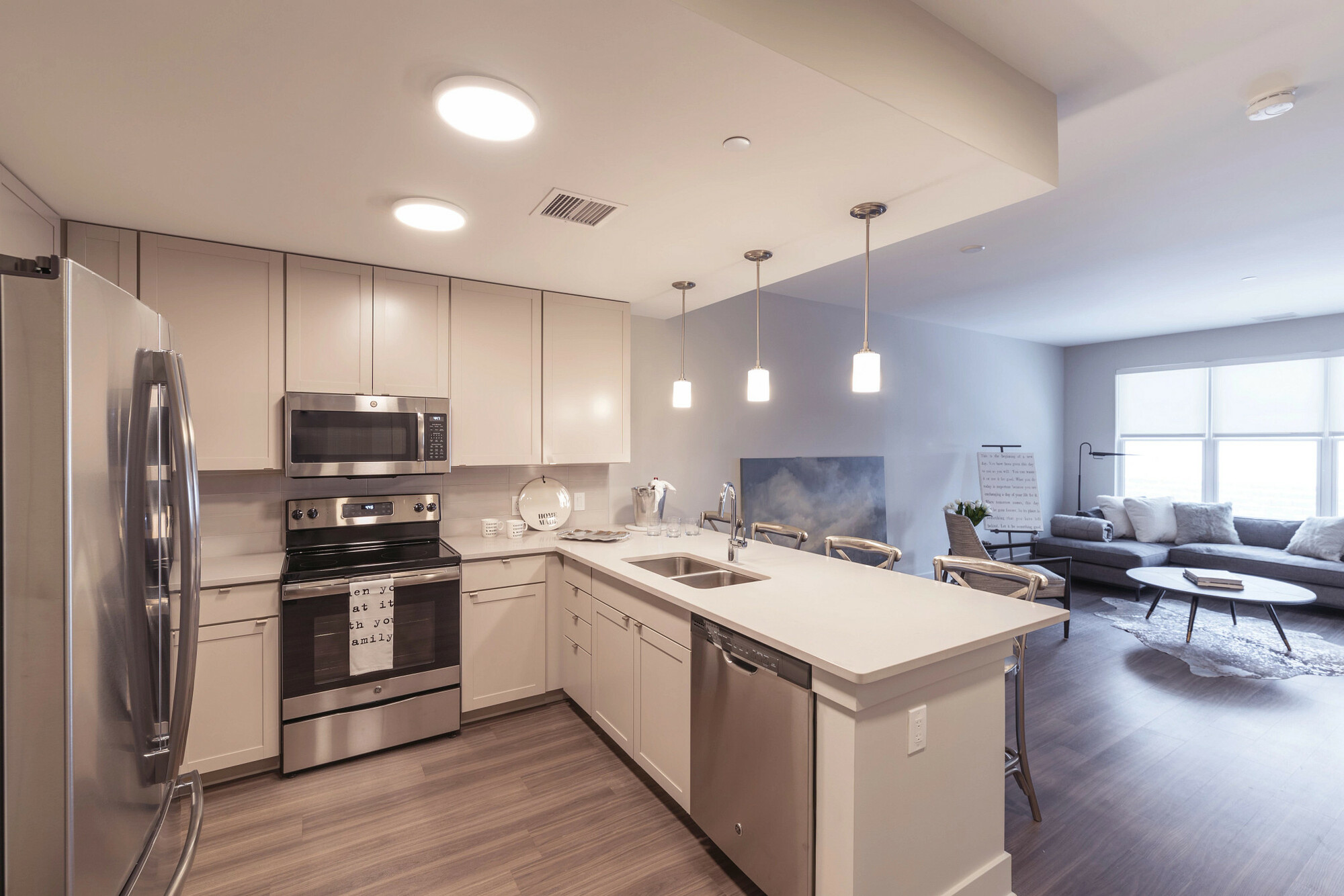 Finished multifamily unit with cabinets, tops, and flooring in one package